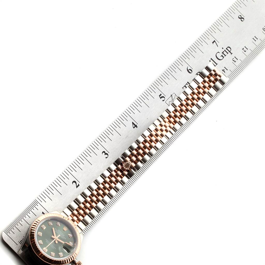 The image shows a Rolex Datejust 279171 Women's Steel and Gold (two tone) Green Dial 279171 Women's Steel and Gold (two tone) Green Dial watch at an angle with the face partially visible, laid next to a ruler measuring the bracelet.
