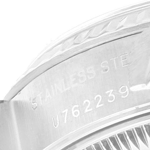 The image shows a close-up of the side of the Rolex Datejust 69174 Women's Stainless Steel Pink Dial 69174 Women's Stainless Steel Pink Dial watch case, revealing the "STAINLESS STEEL" engraving and part of the serial number.