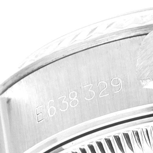 This image shows a close-up of the serial number engraved on the side of the bezel of a Rolex Datejust 69174 Women's Stainless Steel Silver Dial 69174 Women's Stainless Steel Silver Dial watch.