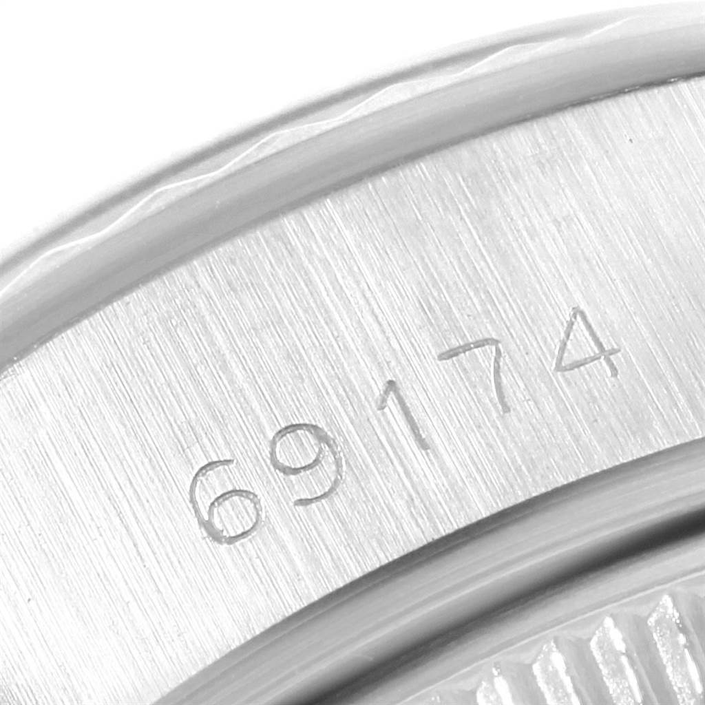 This image shows a close-up of the case and bezel with the engraved model number of a Rolex Datejust 69174 Women's Stainless Steel Silver Dial 69174 Women's Stainless Steel Silver Dial.