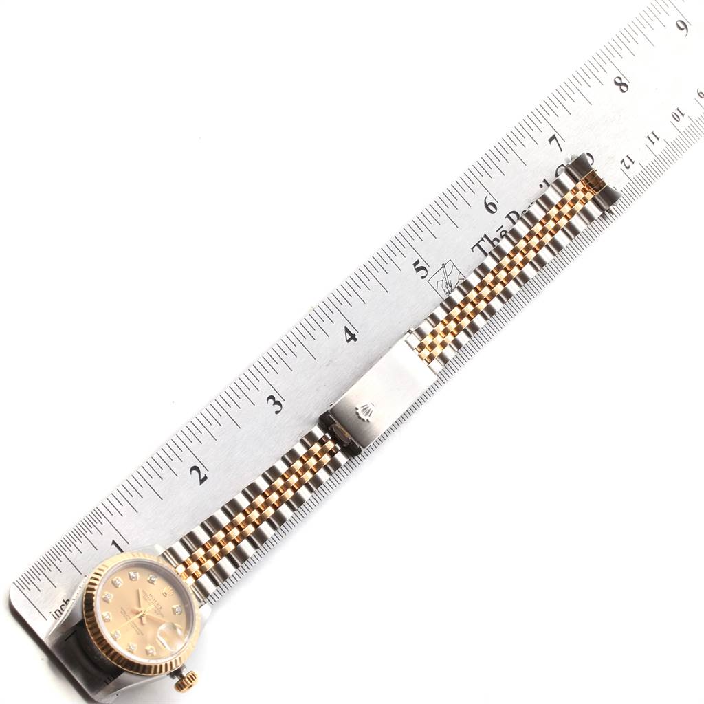 The image shows the front view of a Rolex Datejust 79173 Women's Stainless Steel Champagne Dial 79173 Women's Stainless Steel Champagne Dial watch with its bracelet and clasp, measured against a ruler.