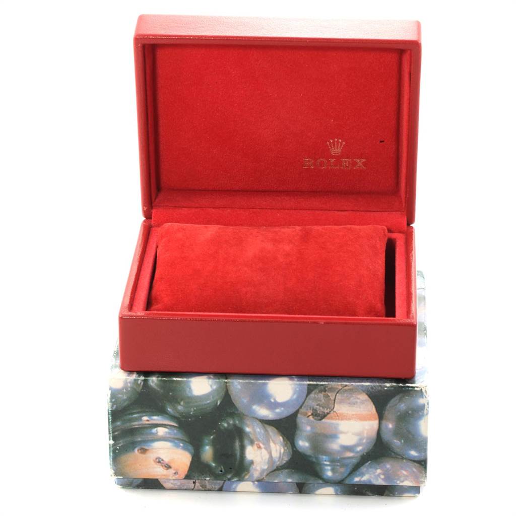 This image shows an open red Rolex watch case, likely for a Datejust model, with a velvet cushion inside.