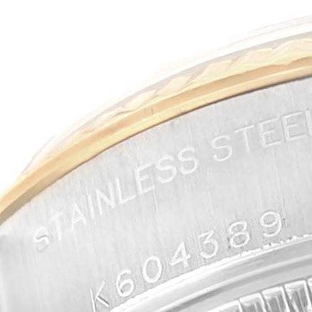 This image shows a close-up of the casing edge of a Rolex Datejust 79173 Women's Stainless Steel Champagne Dial 79173 Women's Stainless Steel Champagne Dial, highlighting the "STAINLESS STEEL" engraving and part of the serial number.