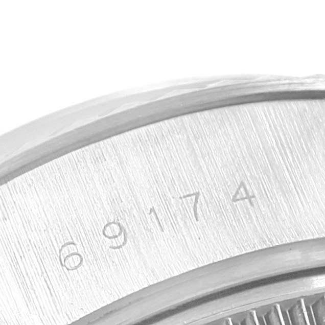 The image shows an oblique close-up of the engraved reference number on the bezel of a Rolex Datejust 69174 Women
s Stainless Steel White Dial 69174 Women
s Stainless Steel White Dial watch.