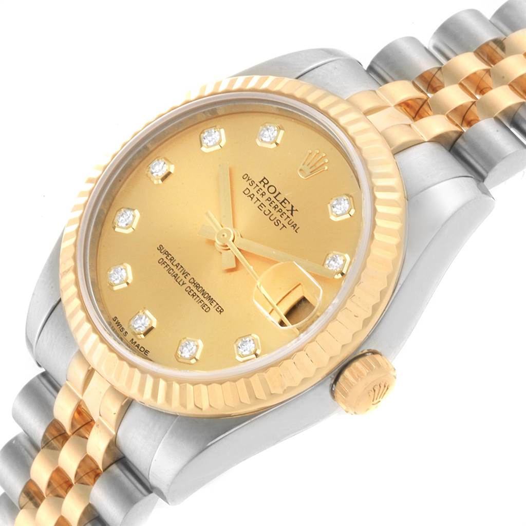 The image shows a close-up angled view of a Rolex Datejust 178273 Women
s Steel and Gold (two tone) Champagne Dial 178273 Women
s Steel and Gold (two tone) Champagne Dial watch, highlighting its gold dial, bezel, and two-tone bracelet.