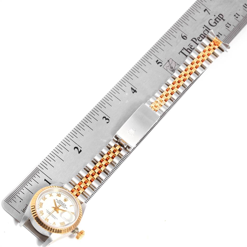 The image shows a Rolex Datejust 69173 Women's Stainless Steel White Dial 69173 Women's Stainless Steel White Dial watch from a top-down angle, including the watch face, bezel, crown, and bracelet resting alongside a ruler.