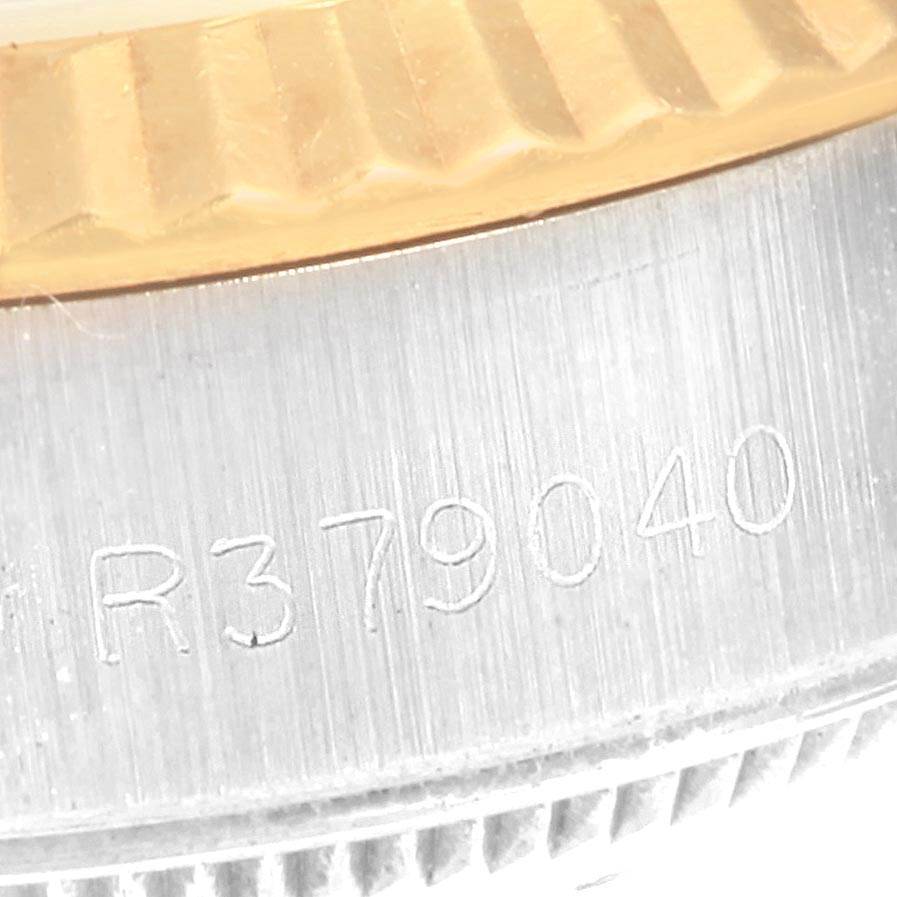 This close-up image shows the serial number engraved on the side of the Rolex Datejust 69173 Women's Stainless Steel White Dial 69173 Women's Stainless Steel White Dial watch bezel and case.