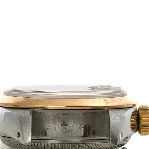 This image shows the side angle of a Rolex Datejust 69163 Women's Stainless Steel Mother of Pearl Dial 69163 Women's Stainless Steel Mother of Pearl Dial watch, highlighting the crown, bezel, and part of the casing with engraved details.