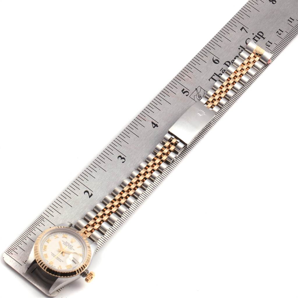 The image shows a flat lay of a Rolex Datejust 69173 Women's Stainless Steel Beige Dial 69173 Women's Stainless Steel Beige Dial watch with its face, bezel, and bracelet partially measured by a ruler.