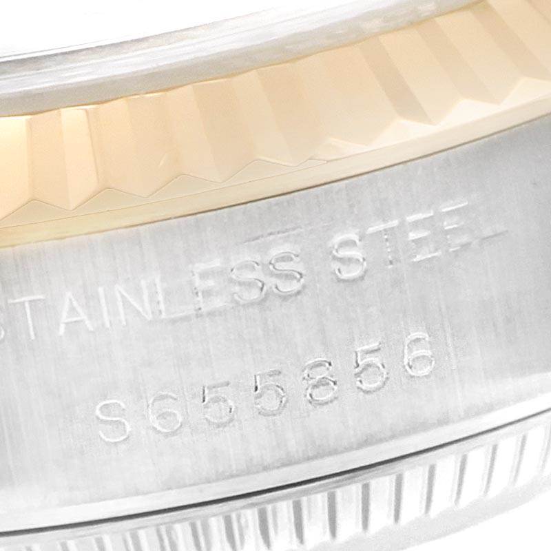The image shows a close-up of the stainless steel case and fluted bezel with engravings on a Rolex Datejust 69173 Women's Stainless Steel Beige Dial 69173 Women's Stainless Steel Beige Dial watch.