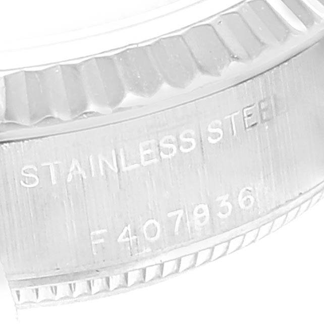 The image shows a close-up of the stainless steel case with engravings on a Rolex Datejust 79174 Women
s Stainless Steel Black Dial 79174 Women
s Stainless Steel Black Dial watch.