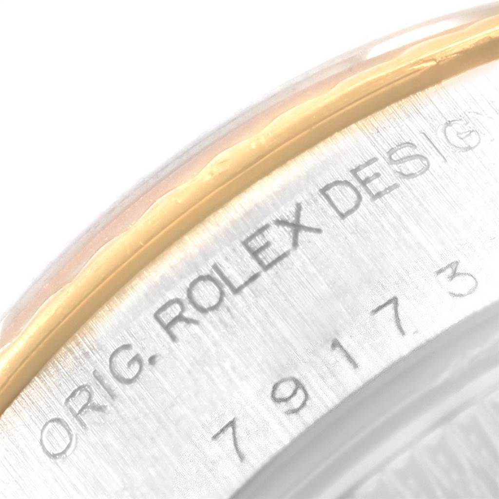 The image shows a close-up of the case back rim of a Rolex Datejust 79173 Women's Stainless Steel Mother of Pearl Dial 79173 Women's Stainless Steel Mother of Pearl Dial, featuring the engraved "ORIG. ROLEX DESIGN" text and part of the bezel.