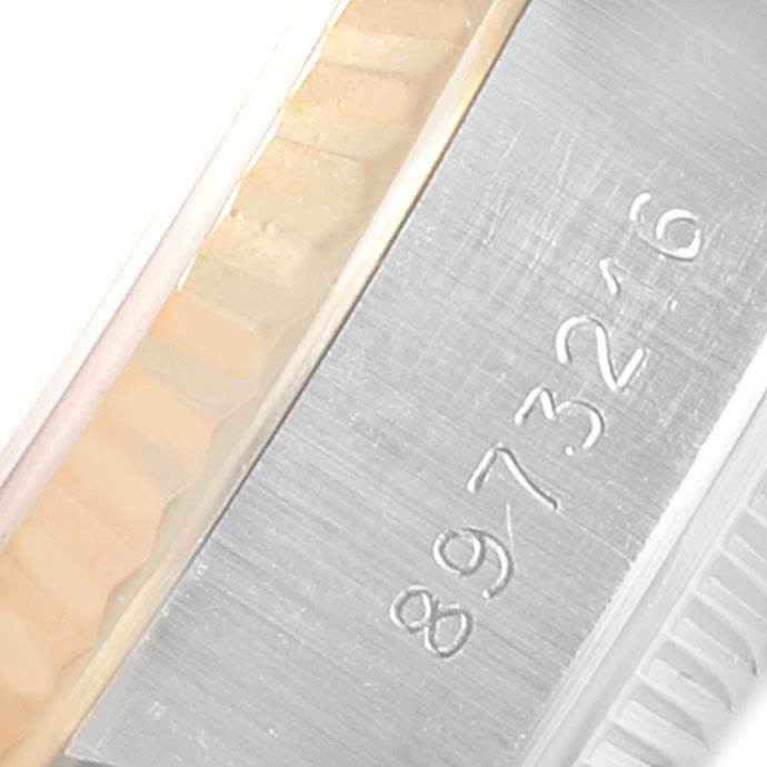 The image shows a close-up of the serial number engraved on the side of a Rolex Datejust 69173 Women's Stainless Steel White Dial 69173 Women's Stainless Steel White Dial watch case.