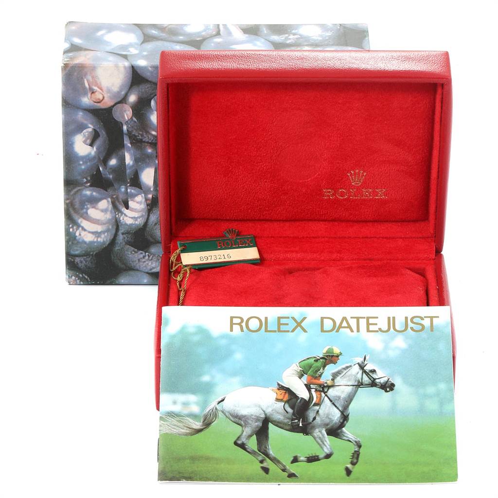 The image shows the red box and booklet for a Rolex Datejust 69173 Women's Stainless Steel White Dial 69173 Women's Stainless Steel White Dial watch, including a tag with a serial number.