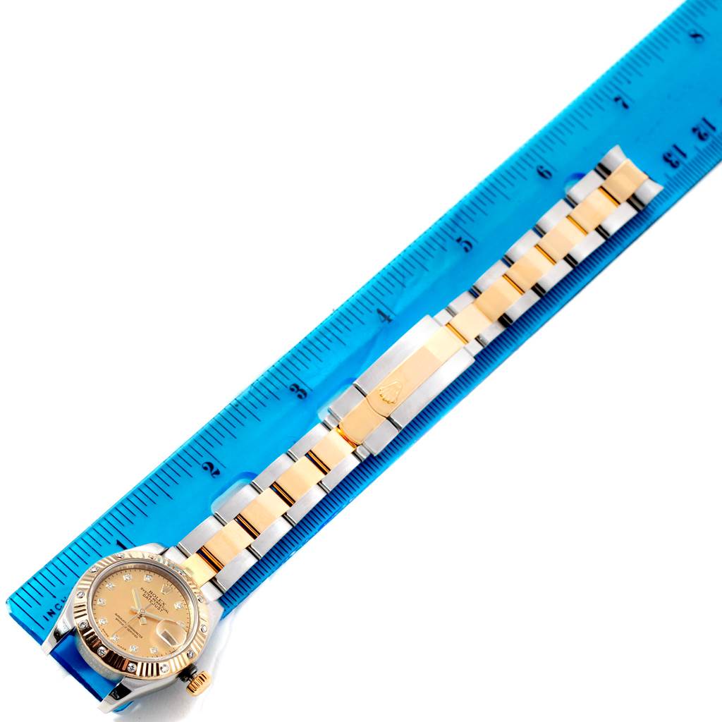 The image shows the Rolex Datejust 179313 Women's Stainless Steel Champagne Dial 179313 Women's Stainless Steel Champagne Dial watch positioned against a ruler, showcasing the face, bezel, and band.