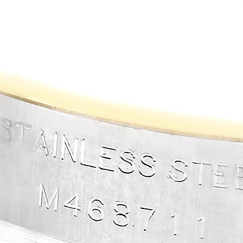 This image shows a close-up view of the serial number and "STAINLESS STEEL" engraving on the case side of a Rolex Datejust 179313 Women's Stainless Steel Champagne Dial 179313 Women's Stainless Steel Champagne Dial.