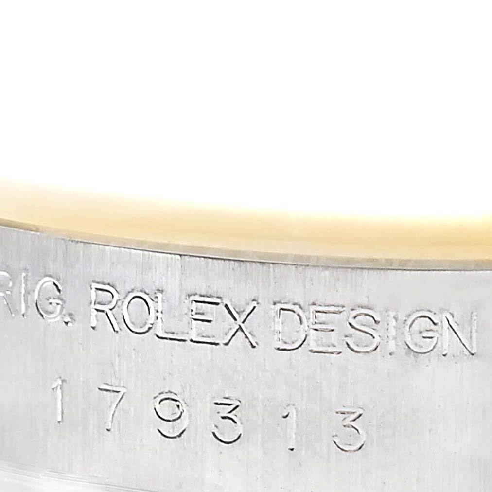 This image shows a close-up of the engraved serial number and "ROLEX DESIGN" inscription on a Rolex Datejust 179313 Women's Stainless Steel Champagne Dial 179313 Women's Stainless Steel Champagne Dial model.
