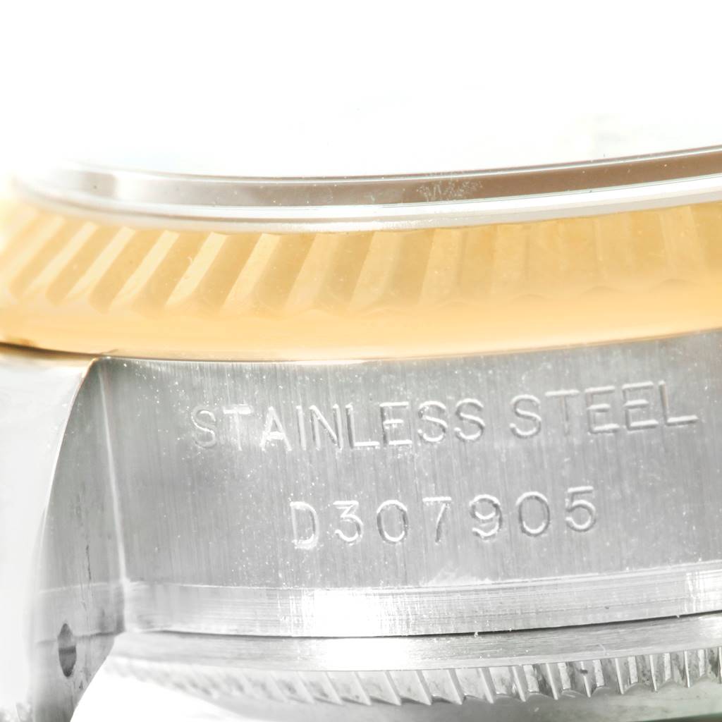 This close-up image shows the engraved side of the stainless steel case and the bezel of a Rolex Datejust 179173 Women's Steel and Gold (two tone) White Dial 179173 Women's Steel and Gold (two tone) White Dial watch.