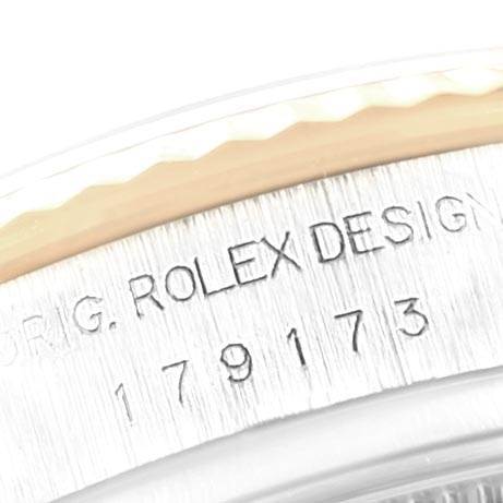 The image shows an angled close-up of the engraved serial number and the design marking on the side of the Rolex Datejust 179173 Women's Steel and Gold (two tone) Mother of Pearl Dial 179173 Women's Steel and Gold (two tone) Mother of Pearl Dial watch.