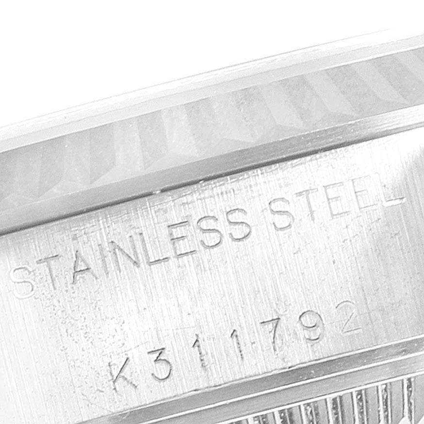 This image shows a close-up of the stainless steel case back and edge of the bezel of a Rolex Datejust 79174 Women
s Stainless Steel Pink Dial 79174 Women
s Stainless Steel Pink Dial model.