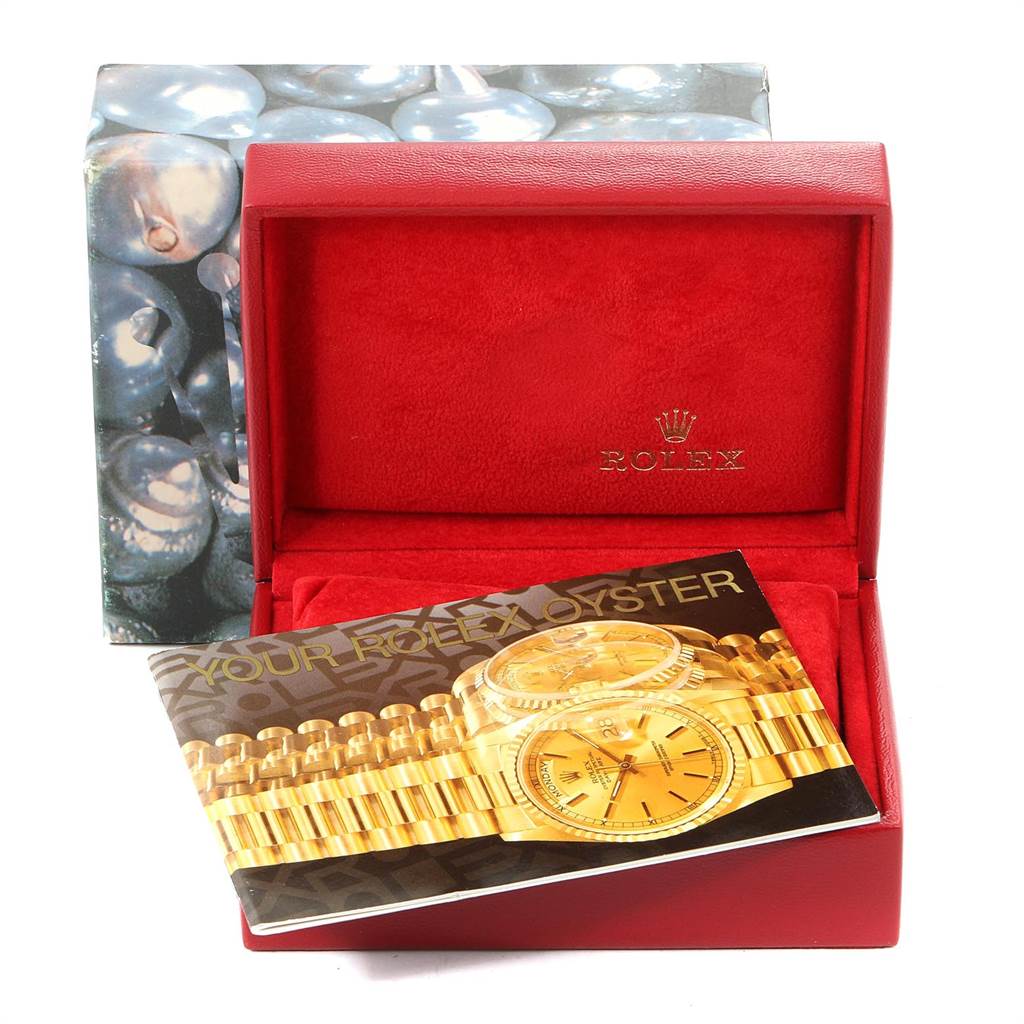 The image shows a red Rolex box and a booklet for the Rolex Datejust 79173 Women's Stainless Steel Silver Dial 79173 Women's Stainless Steel Silver Dial model watch, with a decorative outer box in the background.