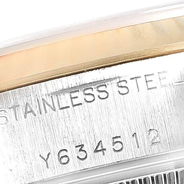 This is a close-up of the side of a Rolex Datejust 79173 Women's Stainless Steel Silver Dial 79173 Women's Stainless Steel Silver Dial watch showing the engraved serial number and "STAINLESS STEEL."