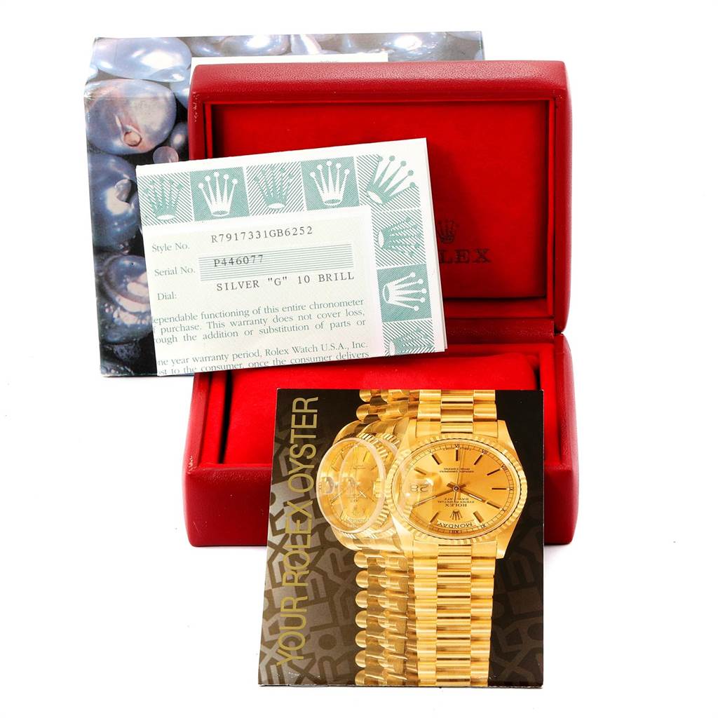 This image shows a Rolex Datejust 79173 Women's Stainless Steel Silver Dial 79173 Women's Stainless Steel Silver Dial model warranty card and brochure inside an open red case.