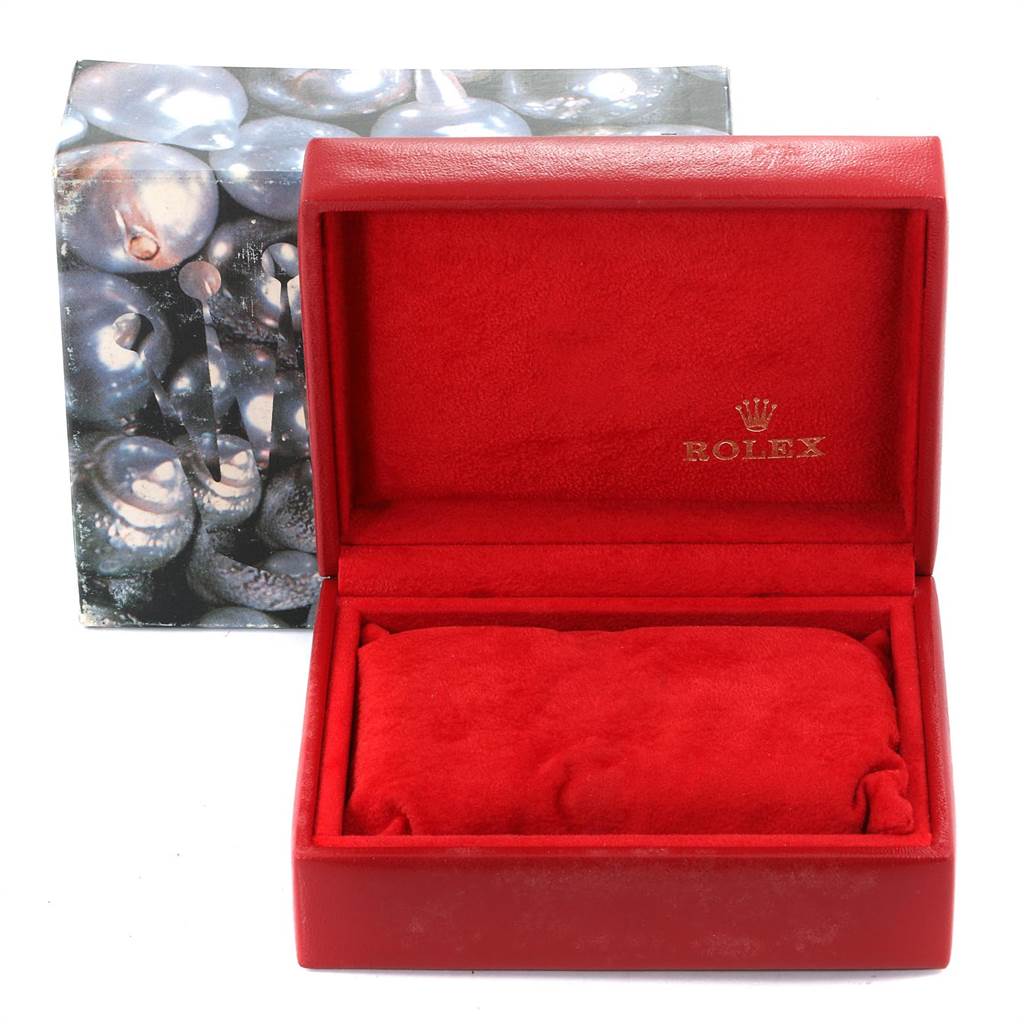 This image shows a red Rolex Datejust 79173 Women
s Steel and Gold (two tone) White Dial 79173 Women
s Steel and Gold (two tone) White Dial watch box and pillow, with a decorative outer box in the background.