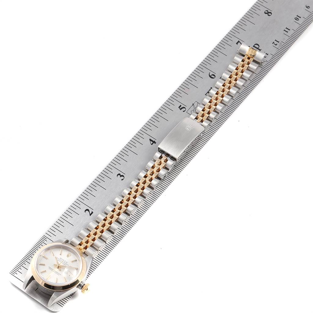 The image shows the front view of a Rolex Datejust 79163 Women's Steel and Gold (two tone) Silver Dial 79163 Women's Steel and Gold (two tone) Silver Dial watch with its bracelet laid flat along a ruler, measuring its length.