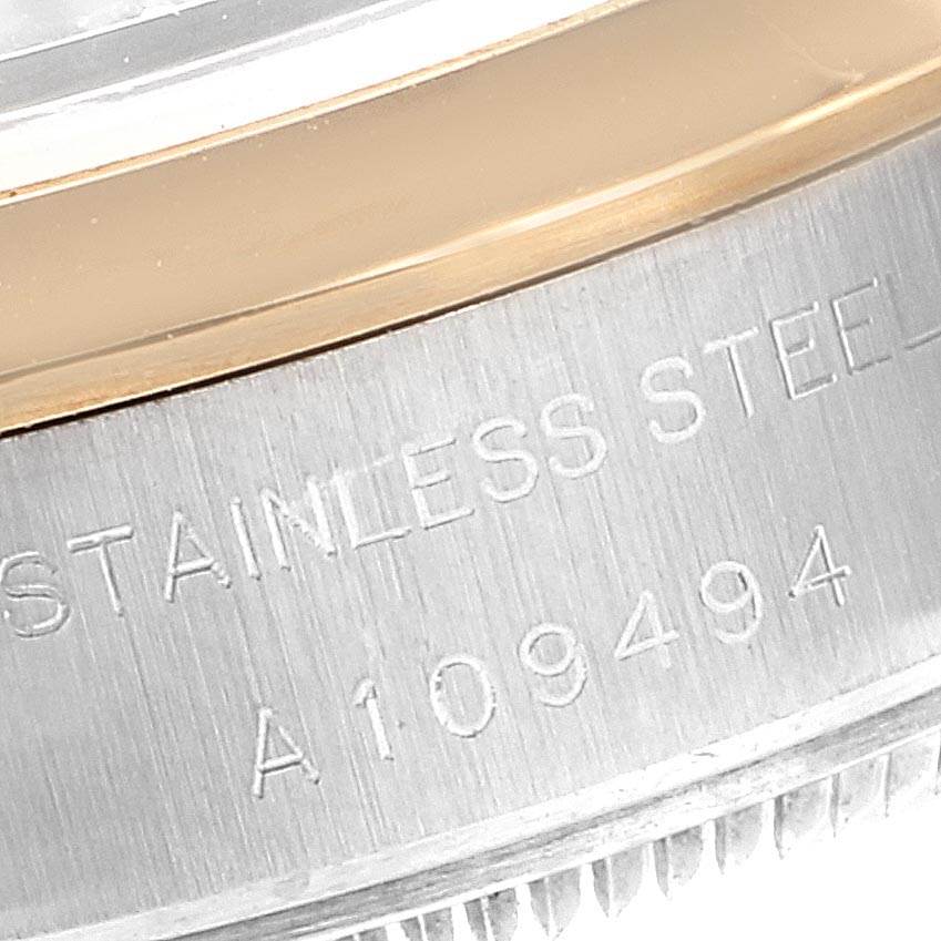 This is a close-up of the case side of a Rolex Datejust 79163 Women's Steel and Gold (two tone) Silver Dial 79163 Women's Steel and Gold (two tone) Silver Dial watch, showing part of the stainless steel case and a portion of the serial number.