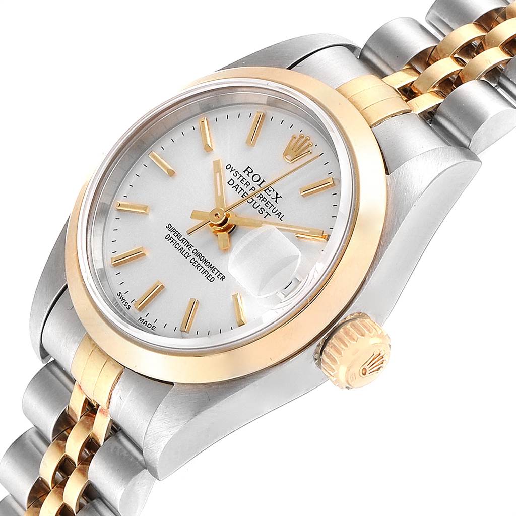 This image shows a close-up of the Rolex Datejust 79163 Women's Steel and Gold (two tone) Silver Dial 79163 Women's Steel and Gold (two tone) Silver Dial watch's dial, bezel, crown, and part of its bracelet at an angle.