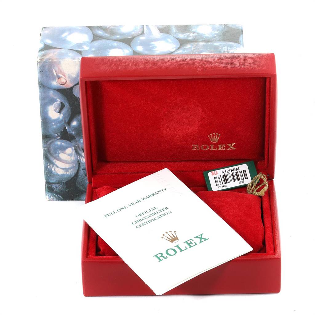 The image shows a Rolex Datejust 79163 Women's Steel and Gold (two tone) Silver Dial 79163 Women's Steel and Gold (two tone) Silver Dial watch box, certification card, warranty booklet, and a green tag.