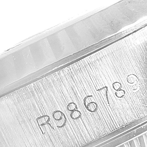 This image shows a close-up of the serial number engraved on the side of the casing of a Rolex Datejust 69174 Stainless Steel Silver Dial 69174 Stainless Steel Silver Dial watch.