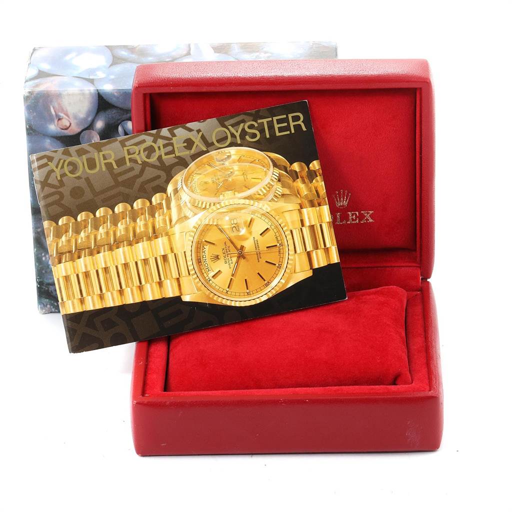 A Rolex Datejust 69174 Stainless Steel Silver Dial 69174 Stainless Steel Silver Dial watch is shown in its red box, with a brochure partially concealing the watch.