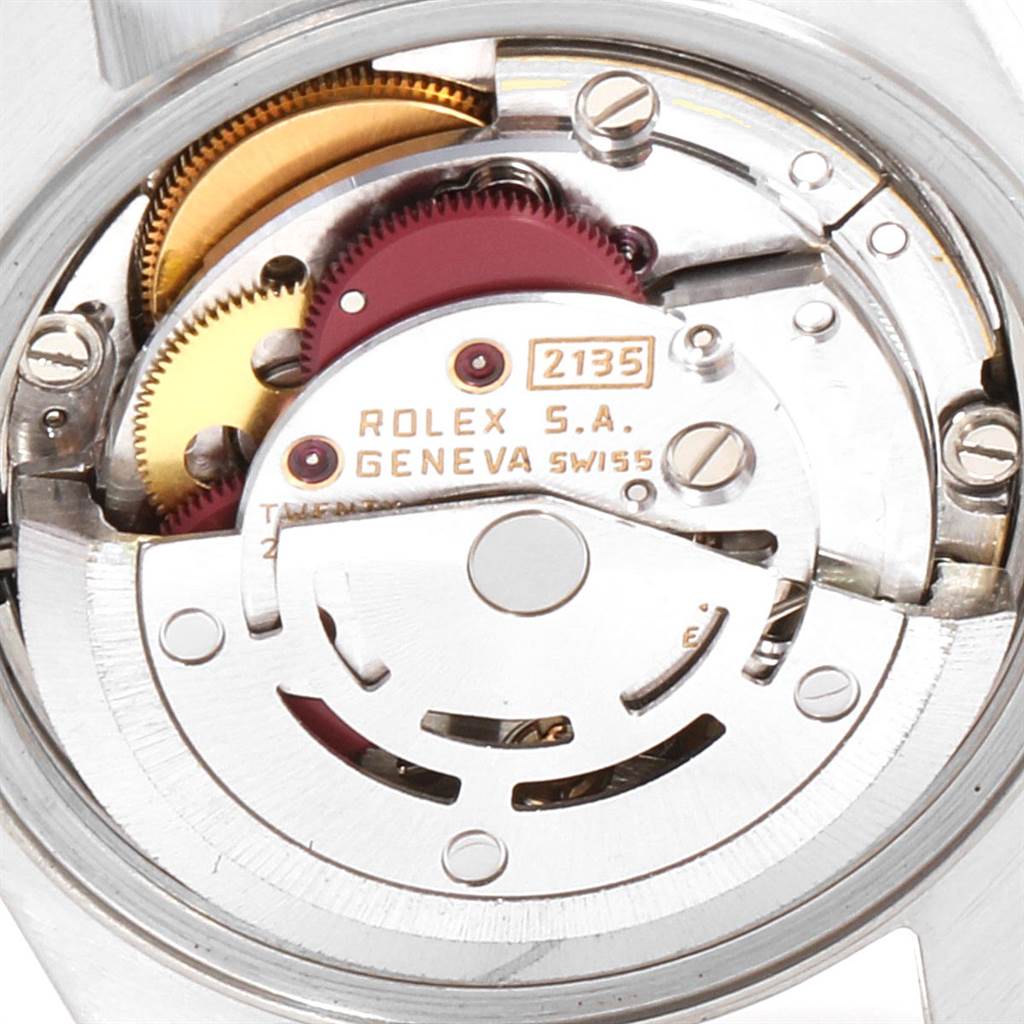 The image shows the internal movement parts of a Rolex Datejust 69174 Stainless Steel Silver Dial 69174 Stainless Steel Silver Dial watch, including gears and the rotor.