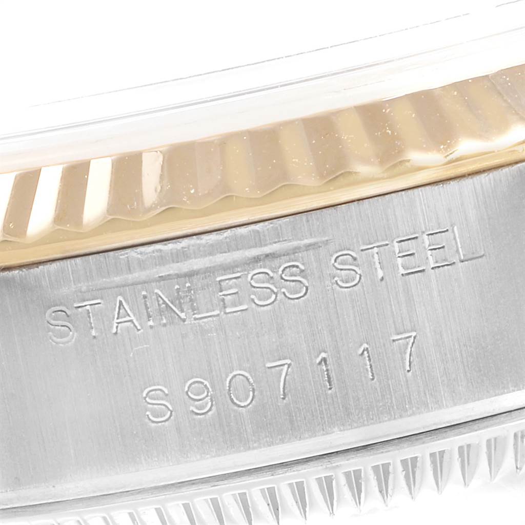This image shows a close-up of the side of a Rolex Datejust 69173 Women's Stainless Steel Champagne Dial 69173 Women's Stainless Steel Champagne Dial watch, focusing on the stainless steel case and engravings.