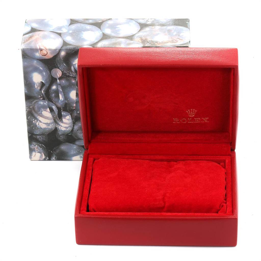 This image shows an open red Rolex Datejust 69173 Women's Stainless Steel Champagne Dial 69173 Women's Stainless Steel Champagne Dial watch box with a cushion inside, viewed from the front.