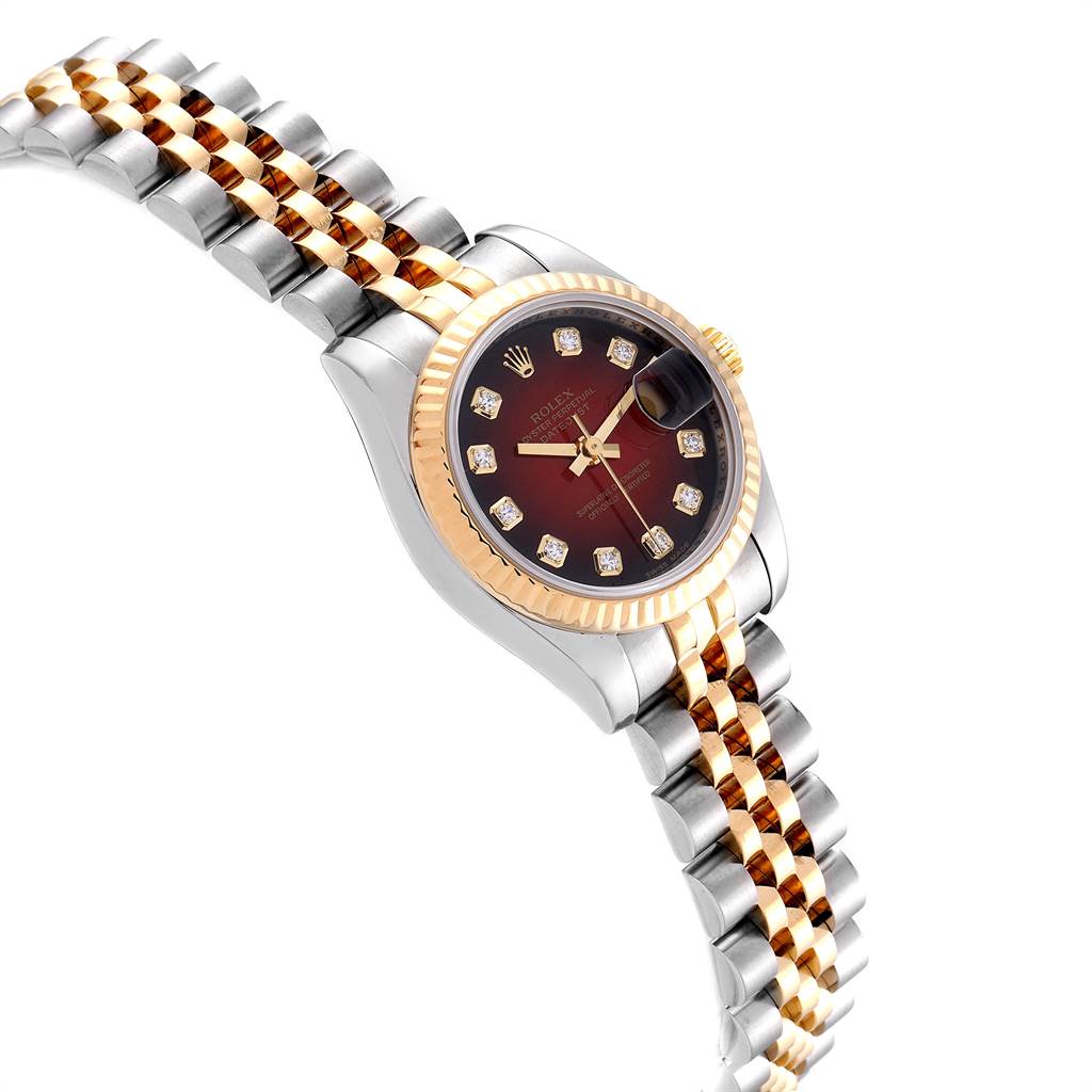 This image shows a Rolex Datejust 179173 Women
s Steel and Gold (two tone) Red Dial 179173 Women
s Steel and Gold (two tone) Red Dial watch with a two-tone bracelet, fluted bezel, and burgundy dial adorned with diamond hour markers.