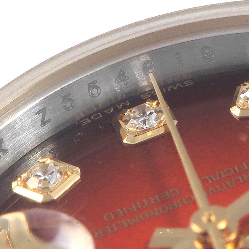 This close-up of the Rolex Datejust 179173 Women
s Steel and Gold (two tone) Red Dial 179173 Women
s Steel and Gold (two tone) Red Dial shows the dial, diamond hour markers, and part of the watch
s face.