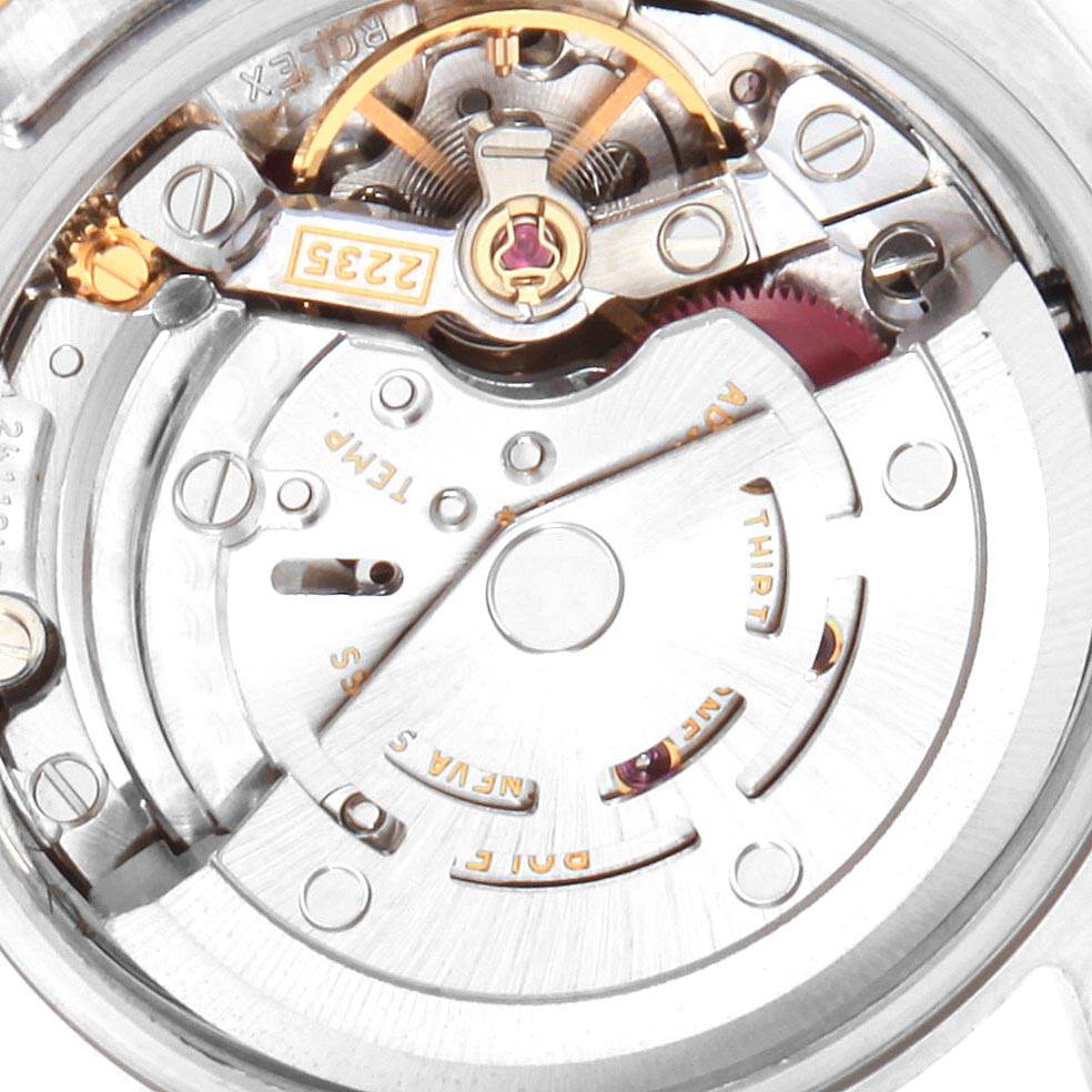 This image shows a close-up of the movement mechanism of a Rolex Datejust 179173 Women
s Steel and Gold (two tone) Red Dial 179173 Women
s Steel and Gold (two tone) Red Dial watch, highlighting the intricate gear and rotor components.