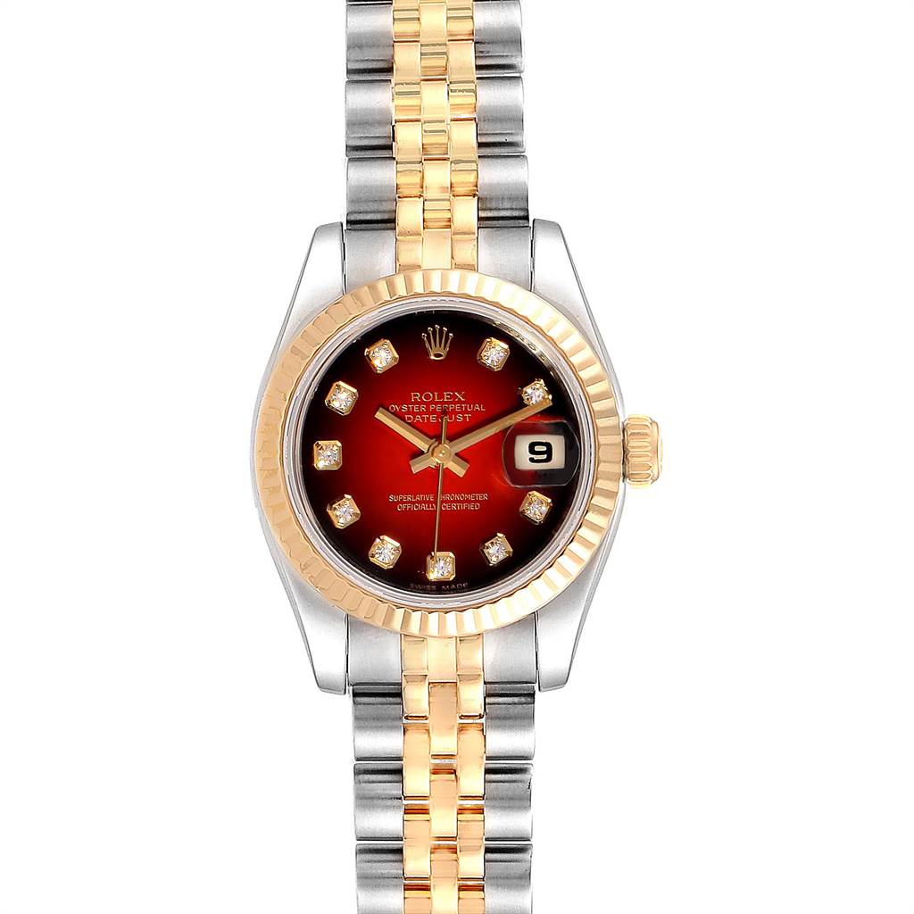 This image shows a Rolex Datejust 179173 Women
s Steel and Gold (two tone) Red Dial 179173 Women
s Steel and Gold (two tone) Red Dial watch from a front angle, highlighting its red dial, diamond markers, fluted bezel, and two-tone bracelet.