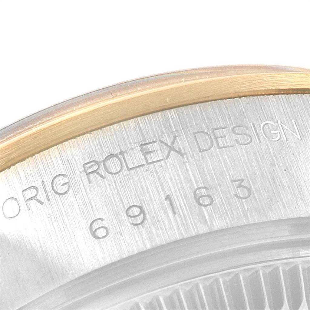 The image shows a close-up of the engraved serial number and "ORIG ROLEX DESIGN" on the case of a Rolex Datejust 69163 Women's Stainless Steel White Dial 69163 Women's Stainless Steel White Dial watch.