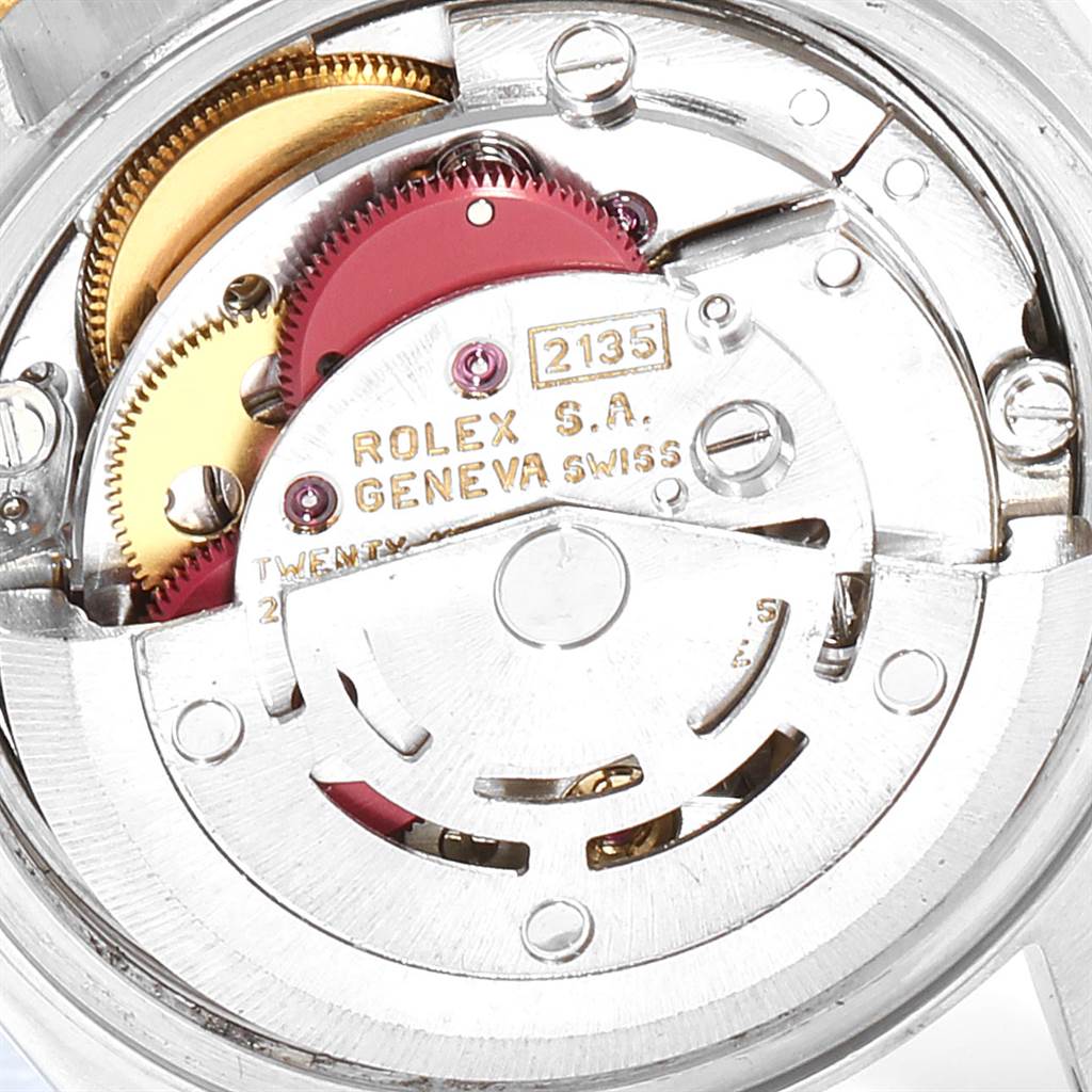 This image shows a close-up view of the Rolex Datejust 69163 Women's Stainless Steel White Dial 69163 Women's Stainless Steel White Dial watch's internal movement components, highlighting the gears and engravings.