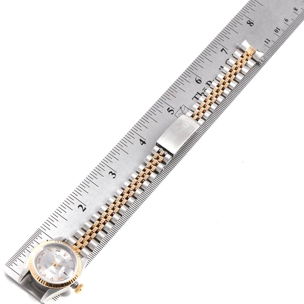 The Rolex Datejust 69173 Women's Stainless Steel Silver Dial 69173 Women's Stainless Steel Silver Dial watch is shown flat with the face and full bracelet visible alongside a ruler for scale.