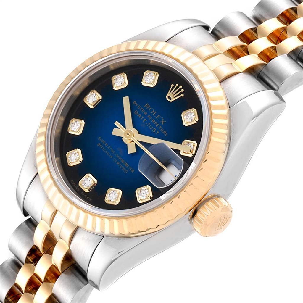The image shows a close-up, angled view of the dial, bezel, crown, and bracelet of a Rolex Datejust 179173 Women
s Steel and Gold (two tone) Blue Dial 179173 Women
s Steel and Gold (two tone) Blue Dial watch.