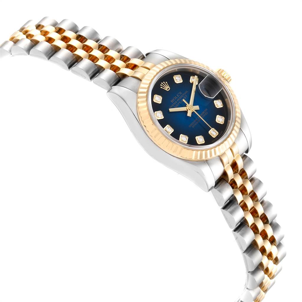 The image shows a Rolex Datejust 179173 Women
s Steel and Gold (two tone) Blue Dial 179173 Women
s Steel and Gold (two tone) Blue Dial watch with a blue dial, fluted bezel, diamond hour markers, and a two-tone Jubilee bracelet at an angled view.