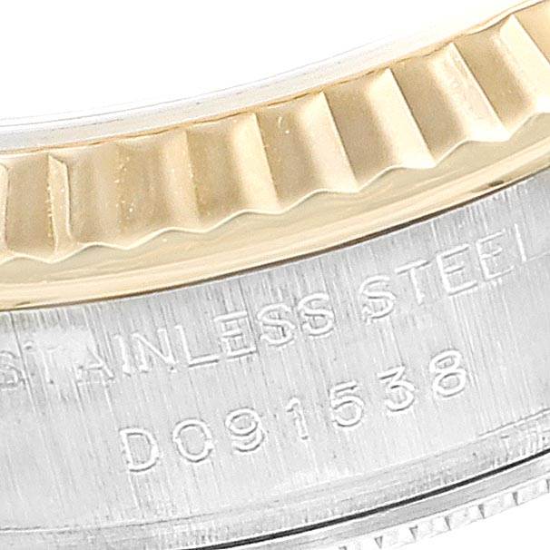 This is a close-up view of the Rolex Datejust 179173 Women
s Steel and Gold (two tone) Blue Dial 179173 Women
s Steel and Gold (two tone) Blue Dial
s fluted bezel and engraved stainless steel case.