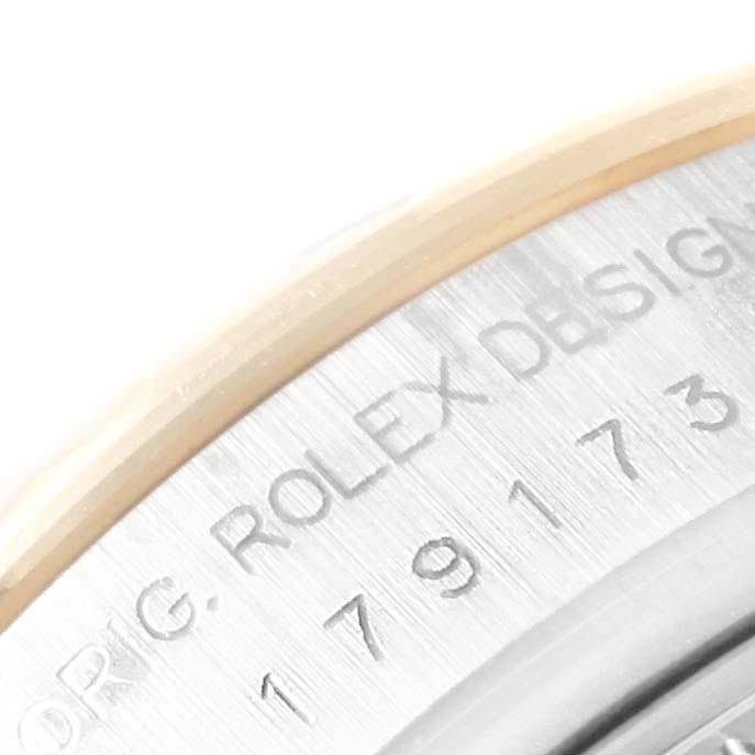 The image shows a close-up of the case back edge of a Rolex Datejust 179173 Women's Steel and Gold (two tone) White Dial 179173 Women's Steel and Gold (two tone) White Dial watch, displaying the model number and "ROLEX DESIGN" engraving.