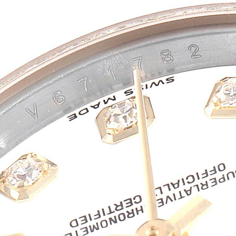 This close-up image of a Rolex Datejust 179173 Women's Steel and Gold (two tone) White Dial 179173 Women's Steel and Gold (two tone) White Dial watch shows part of the dial, diamonds, and the text "Swiss Made" along with the serial number.