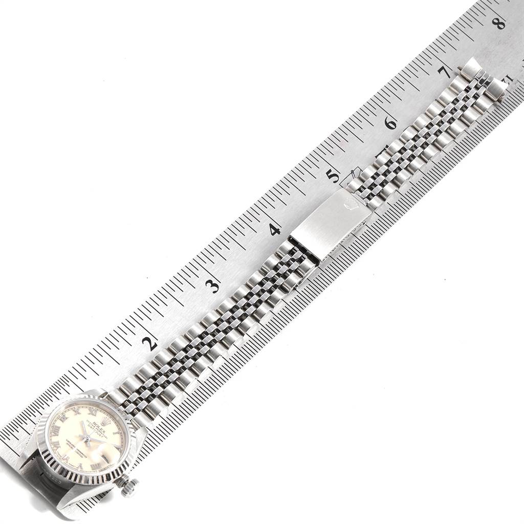 The image shows a Rolex Datejust 69174 Women's Stainless Steel Beige Dial 69174 Women's Stainless Steel Beige Dial watch laid flat, with its bracelet aligned against a ruler for measurement.